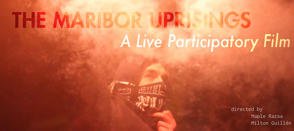 The Marior Uprisings a Live Participatory Film. A person in a hoodie and bandana stands in thick orange colored smoke.